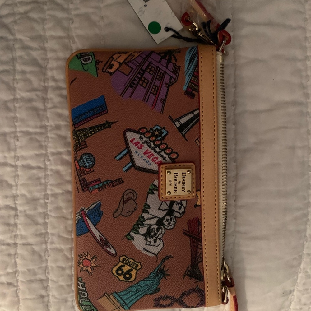 Dooney & Bourke wristlet, 8 in. Never used. Super cute